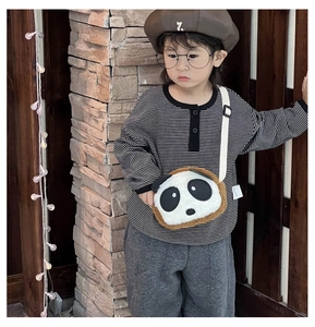 Detail of cute panda plush crossbody bag with adjustable strap worn by a toddler