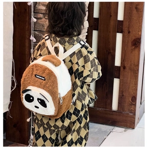Toddler wearing a cute panda plush backpack with soft brown and white faux fur