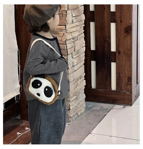 Detailed close-up of a plush panda shoulder bag with adjustable strap for kids