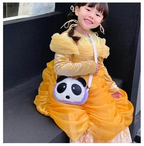 Detail of plush panda crossbody bag for kids paired with a yellow lace princess dress