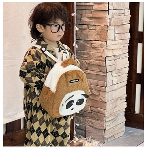 Detailed view of plush panda backpack showing soft texture and fashion embroidery label