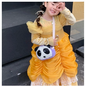 Cute purple panda plush crossbody bag worn by a child in a yellow dress outdoors