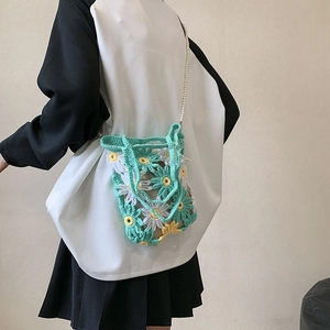 Handmade crochet floral handbag in mint green with daisy pattern and pearl chain strap