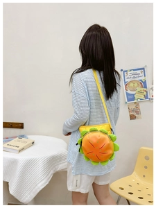 Detail of cute burger-shaped kids crossbody bag with vibrant yellow and orange PU leather