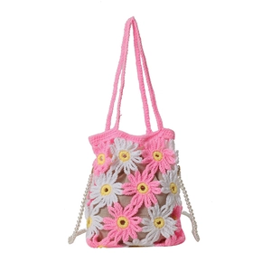 Handmade crochet floral handbag with pink daisy patterns and elegant pearl chain straps