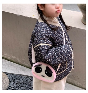 Close-up of a pink plush panda crossbody bag for kids paired with a floral quilted jacket