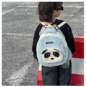 Close-up of plush panda backpack for kids featuring soft light blue and cream fabric