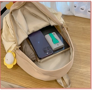 Macro view of beige backpack interior showing spacious storage for phone and accessories