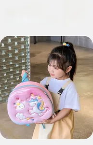 Detail shot of 3D embossed unicorn design on a pink toddler backpack with blue straps