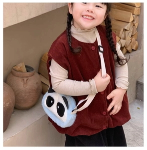 Detail of cute panda plush bag paired with a burgundy corduroy vest for autumn kids outfit