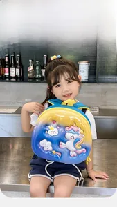 Detail view of 3D unicorn relief and gradient hard shell on a kid's backpack