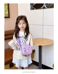 Close-up of kids lavender crossbody bag with large glitter butterfly detail and sequins