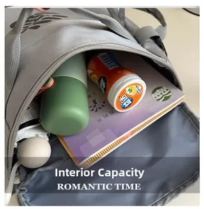 Detailed interior of grey waterproof nylon backpack showing large capacity for books and water bottles