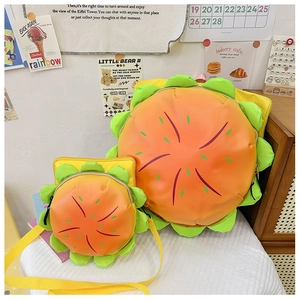Detail of creative burger-shaped kids backpack and crossbody bag set on a white desk