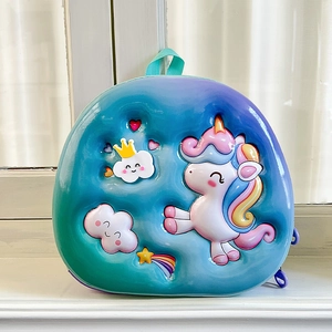 Detail of 3D embossed unicorn on children's backpack with blue-green gradient finish