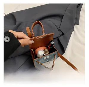Internal view of a mini denim crossbody bag showing storage for lipstick and small items