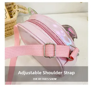 Detail view of the adjustable woven shoulder strap and silver metal buckle on pink bag