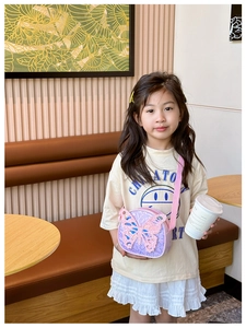 Close-up of children purple sequin crossbody bag with 3D butterfly and pink strap