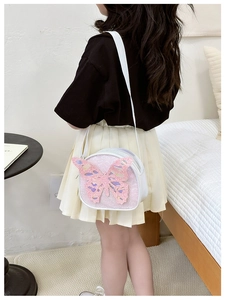 Close-up of kids pink sequin crossbody bag with large 3D butterfly decoration