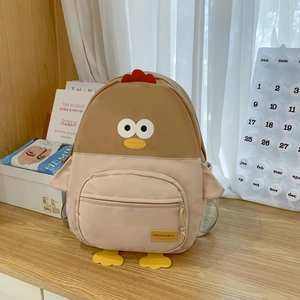 Detail of cute chick-themed cartoon backpack with 3D wings and waterproof nylon fabric