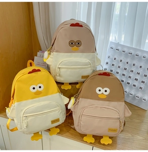 Detailed view of three cute cartoon chick backpacks in various soft pastel color combinations