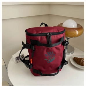 Detail of burgundy kid's travel backpack with double zippers and adjustable straps