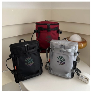 Three waterproof nylon backpacks in black, red, and grey with reflective palm print