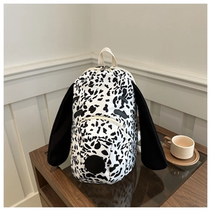 Close-up of cute dalmatian puppy backpack featuring long black ears and spotted pattern