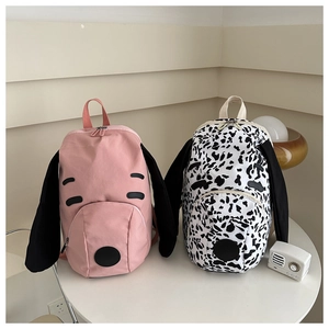 Close-up of cute dog-shaped canvas backpacks in pink and spotted patterns for girls