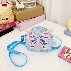Detail of blue sequin kids shoulder bag with a 3D pink glitter butterfly and strap