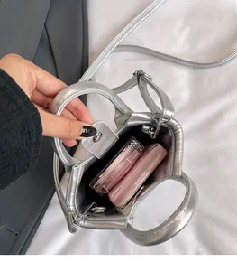 Top view of compact silver bucket bag showing spacious interior with makeup organizer