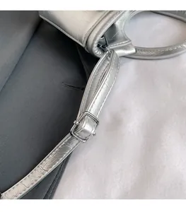 Macro shot of silver metallic leather texture and high-quality adjustable buckle detail