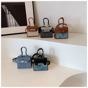 Detailed look at mini trapezoid handbags with metal twist locks and color-block designs