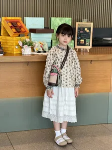 Mini color-block bucket bag for girls with adjustable strap shown on a child model