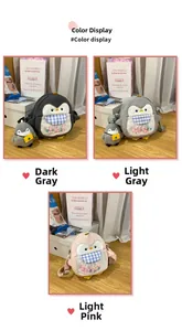 Plush penguin crossbody bags in dark grey, light grey, and pink with colorful pom-poms