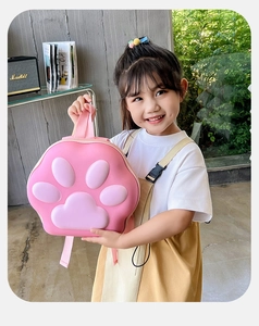 Détail du sac à dos rigide en EVA patte de chat rose tenu par une petite fille