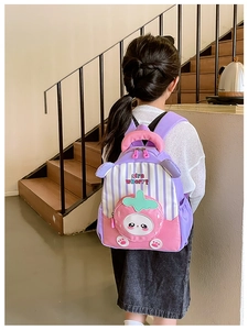 Rear view of child wearing strawberry stripe schoolbag with 3D cute cartoon pocket