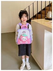 Detail of strawberry shaped pocket and colorful stripes on the kids' backpack