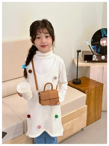 Détail du sac bandoulière marron pour enfants en cuir et texture tissée mixte