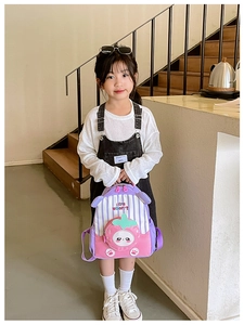 Detail of cute strawberry backpack with pink and purple stripes for kindergarten kids