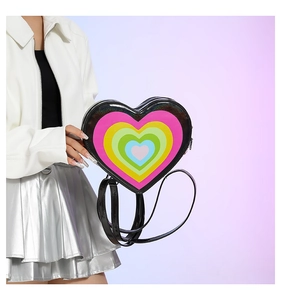 Macro detail of the heart-shaped backpack featuring multi-color layered glossy leather