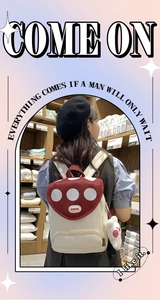 Detail of cute mushroom backpack with red polka dot flap and white rabbit plush pendant