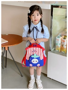 Toddler girl wearing strawberry striped backpack with cute cartoon rabbit front pocket