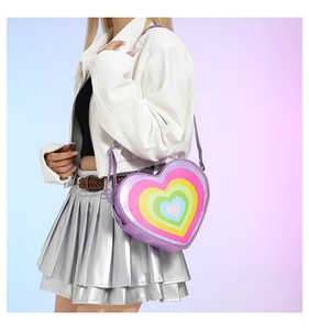 Y2K style heart-shaped rainbow crossbody bag in purple metallic PU worn by a model