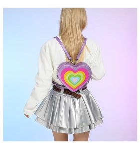 Detail of a heart-shaped rainbow backpack with purple glitter edges and shoulder straps