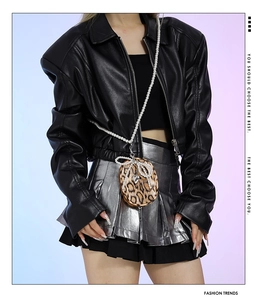 Fashionable leopard print mini bag with pearl chain and bow detail on trendy outfit