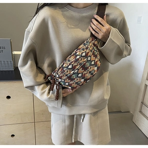 Detail of vintage ethnic geometric jacquard fabric and double zipper on the crossbody chest bag