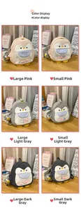 Detailed view of cartoon penguin backpacks in pink and grey, showing large and small sizes