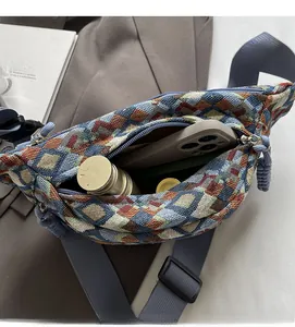 Macro view of woven geometric chest bag showing spacious interior for phone and water bottle