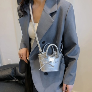 Mini silver star tote bag with bow charm in metallic finish for women, millennial style
